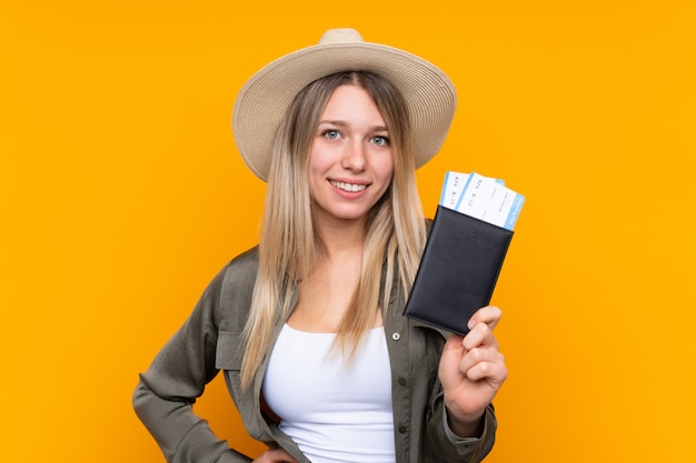 Young blonde woman happy in vacation with passport and plane tickets