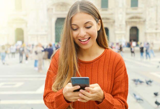 Young blonde woman holding phone