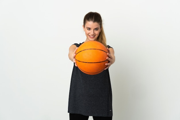 Young blonde woman over isolated background playing basketball