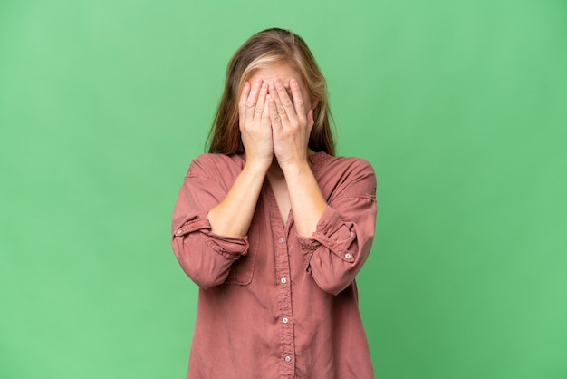 Young blonde woman over isolated background with tired and sick expression