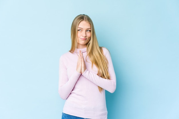 Young blonde woman isolated on blue background making up plan in mind, setting up an idea.