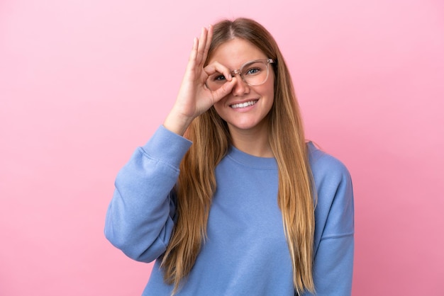 Giovane donna bionda isolata su sfondo rosa con gli occhiali con felice espressione