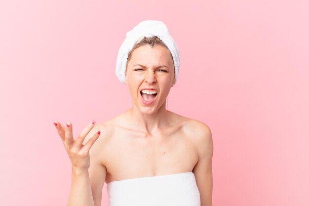 Young blonde woman looking angry, annoyed and frustrated and after shower