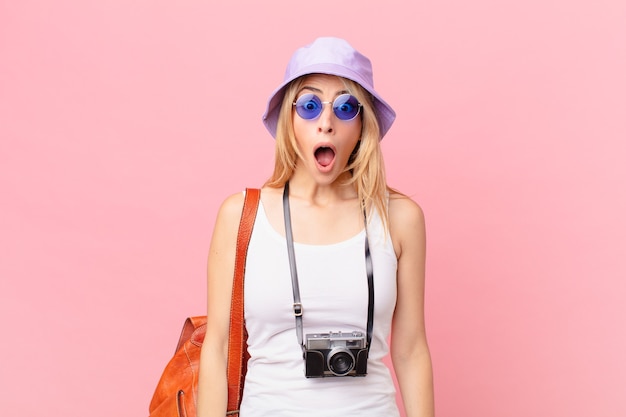 Young blonde woman looking very shocked or surprised