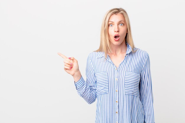 Young blonde woman looking very shocked or surprised