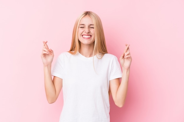 Young blonde woman on pink