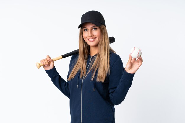 Young blonde woman playing baseball