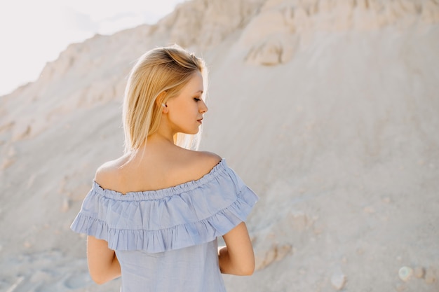 Young blonde woman portrait, outdoors.