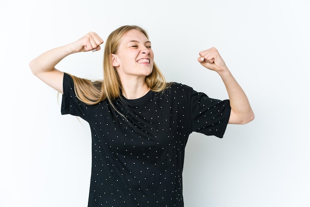 Young blonde woman raising fist after a victory, winner concept.