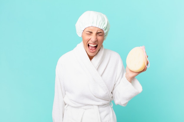 Young blonde woman shouting aggressively, looking very angry. shower concept.