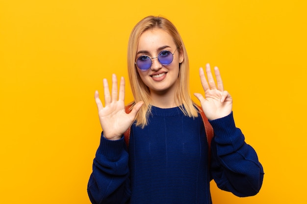 Young blonde woman smiling and looking friendly