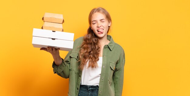 Young blonde woman taking fast food away