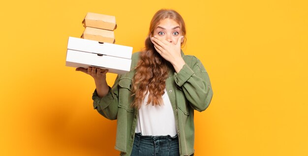 Young blonde woman taking fast food away