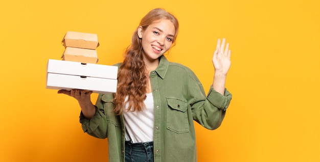 Giovane donna bionda che porta via il fast food