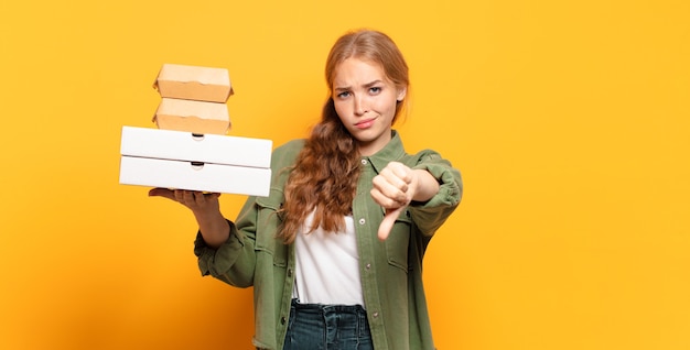 Young blonde woman taking fast food away