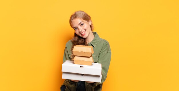 Young blonde woman taking fast food away