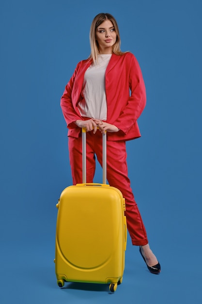 Young blonde woman with baggage. Travel concept