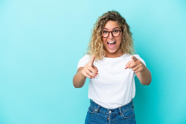 Young blonde woman with curly hair holding a take away coffee