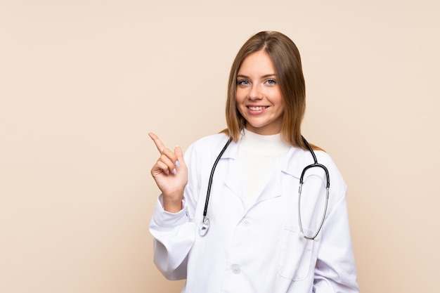 Young blonde woman with doctor gown and pointing side