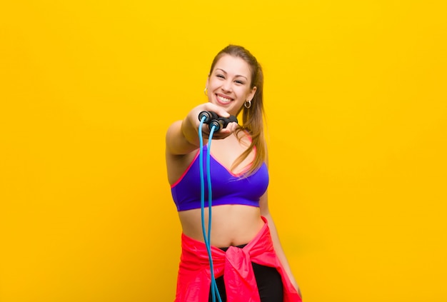 Young blonde woman with a jump rope. sport concept