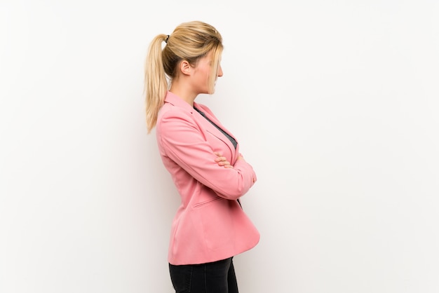 Young blonde woman with pink suit in lateral position