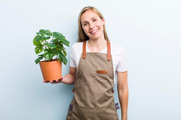 Young blonde woman with plants gardering concept