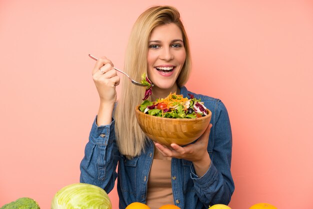 Young blonde woman with salad