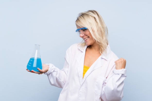 Young blonde woman with a scientific test tube and celebration