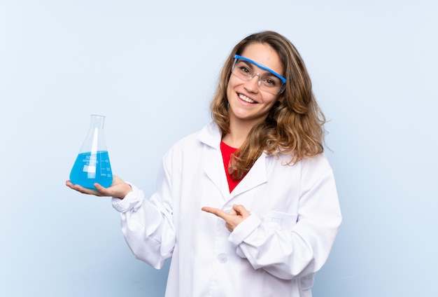 Young blonde woman with a scientific test tube and pointing it