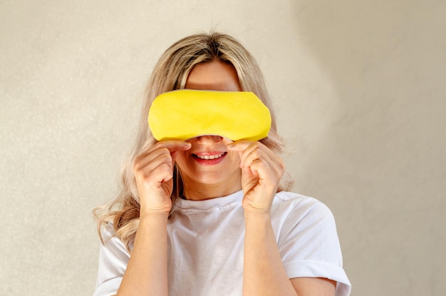 Young blonde woman with sleeping mask having fun and relaxing at home Wellness and chilling concept quality of sleep good night insomnia relaxation healthy night sleep