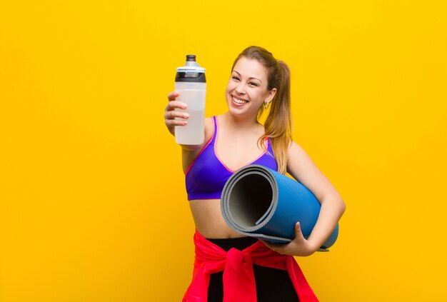 Young blonde woman with a yoga mat. sport concept