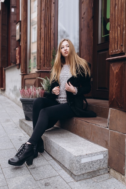 Young blondie woman in old city center