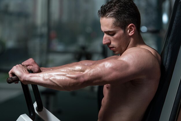 Young Bodybuilder Doing Heavy Weight Exercise For Chest