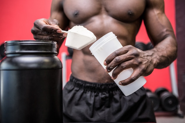 Young Bodybuilder filling his Bottle