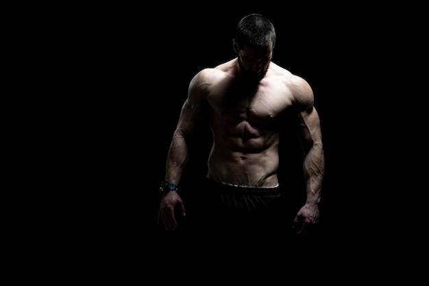 Young Bodybuilder Flexing Muscles  Isolate on Black Blackground  Copy Space