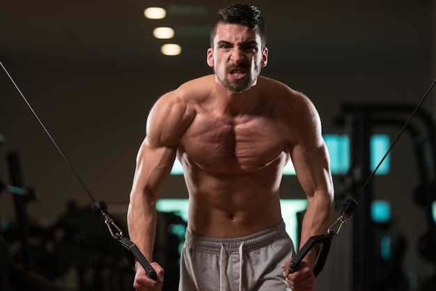 Young Bodybuilder Is Working On His Chest With Cable Crossover In Gym