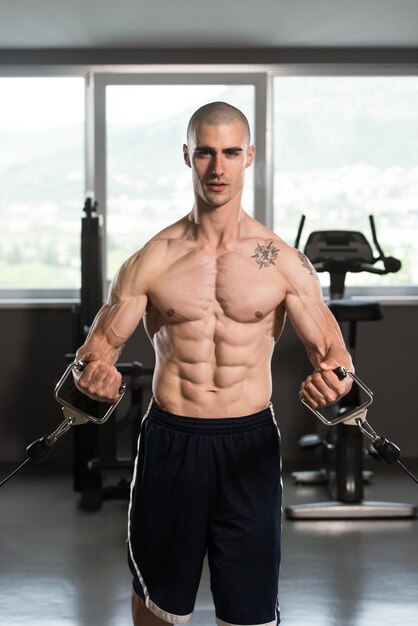 Young Bodybuilder Is Working On His Chest With Cable Crossover In Gym