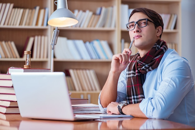 Young book writer writing in library