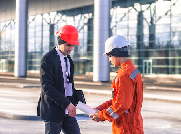 Young boss and worker in conversation discussing construction project