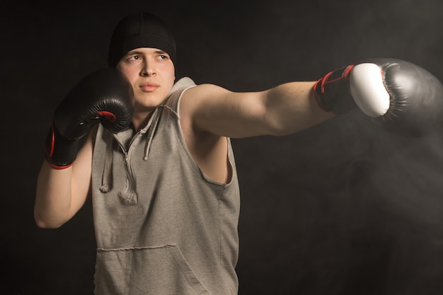 Young boxer throwing a punch with his gloved fist