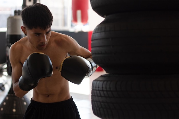 Young boxer training with fury and determination on his face