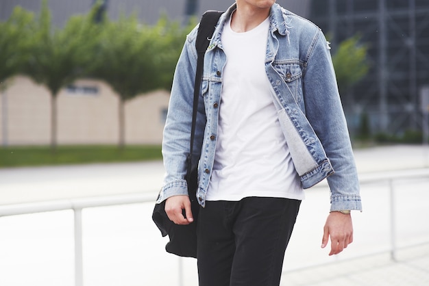 Young boy in a blue denim jacket on the street.