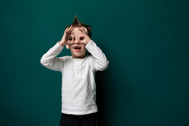 Young boy covering his eyes with his hands