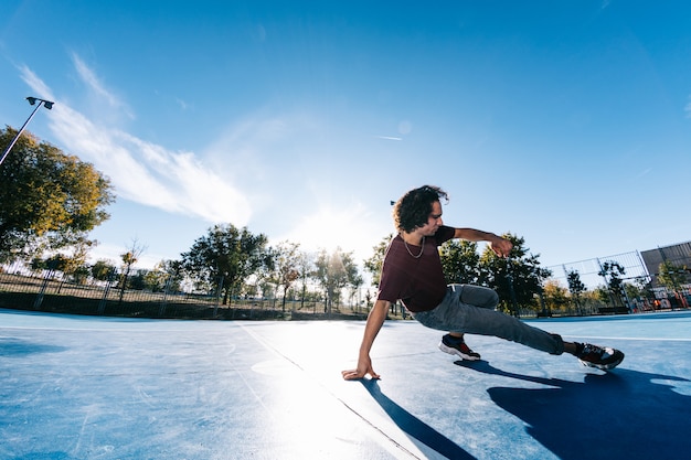 Young boy dancing and posing at basketball court