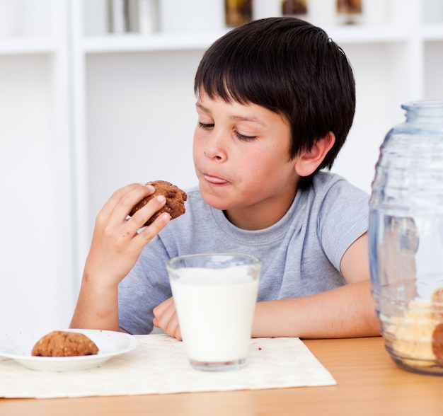 Young boy eating biscuits