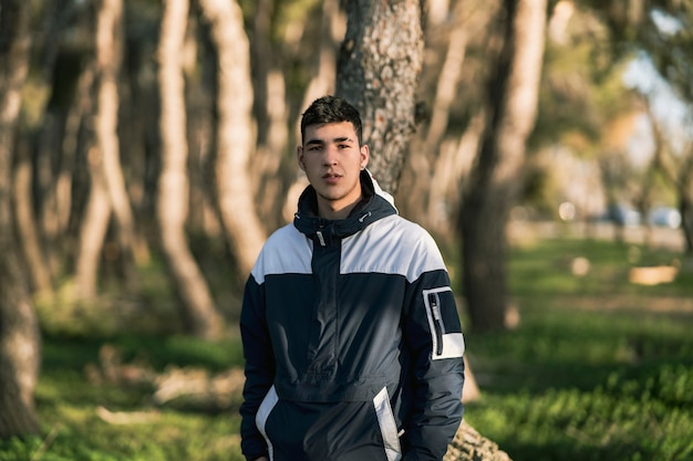 Young boy in a forest with sportswear