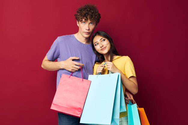 Young boy and girl colorful bags shopping fun Lifestyle unaltered