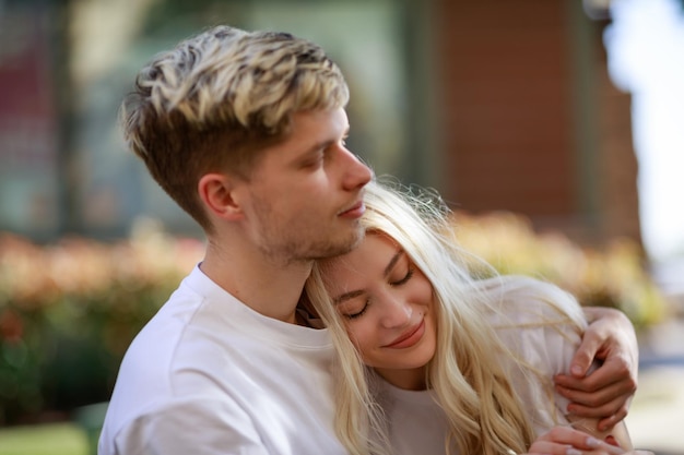 The young boy and girl hugged each other and sat at the park High quality photo