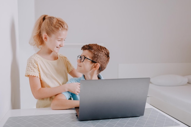 Young boy and girl learning together from home School from home during the pandemic