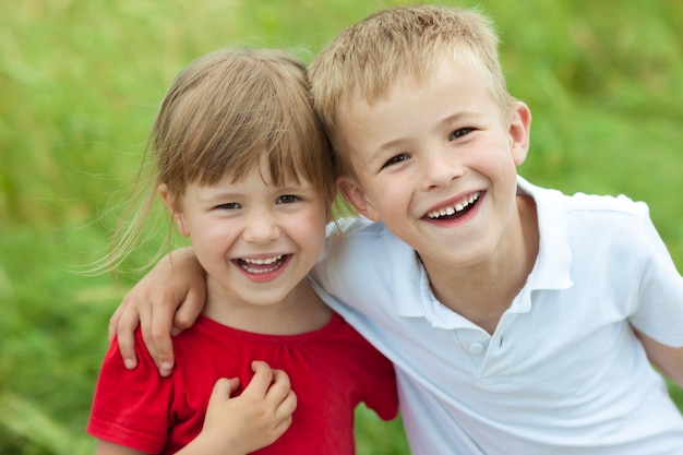 Young boy and girl together laughing happily